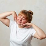 a person with the hands on the face